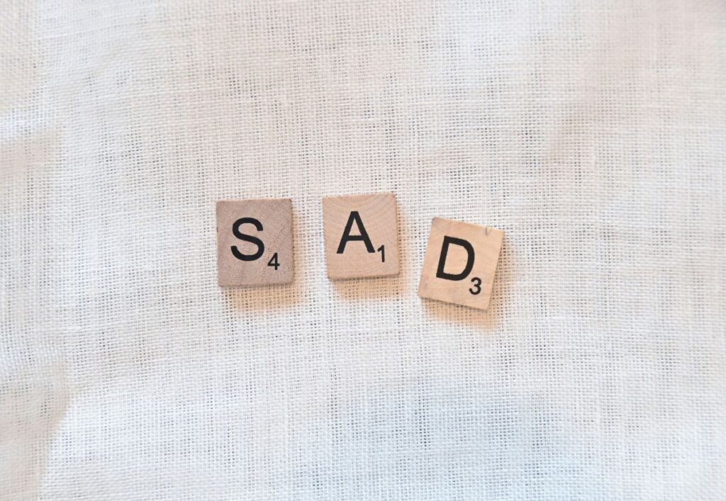 "sad" spelled out with scrabble pieces - 10 stages of pet grief